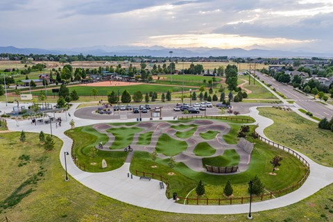 A park with a playground and a walking path.