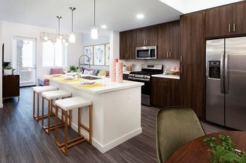 A kitchen with a white island and wooden cabinets.
