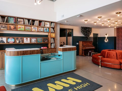 A reception area with a blue reception desk and a red sofa.