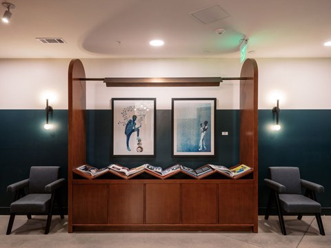 A room with a wooden bench and two chairs.