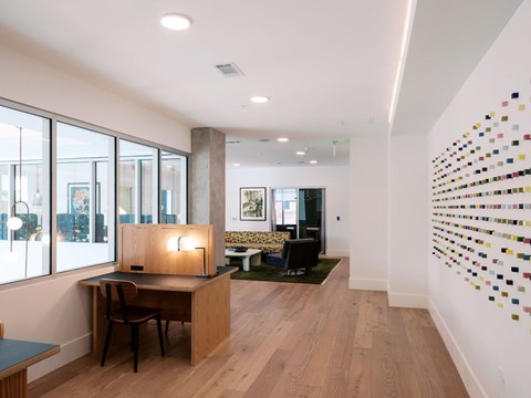 A room with a desk and a chair in it.