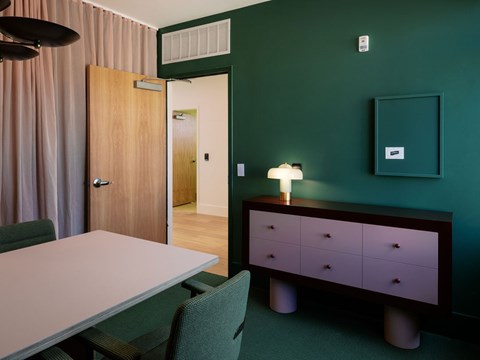 A room with a green wall and a wooden door.