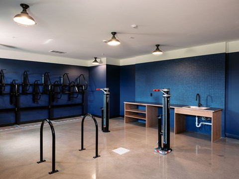 A room with a blue wall and a black pole in the middle.