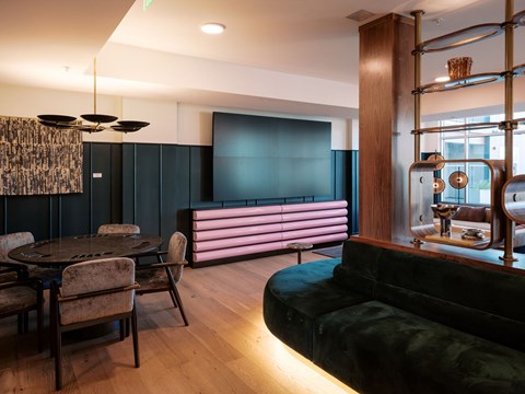A modern living room with a black couch and a round table.