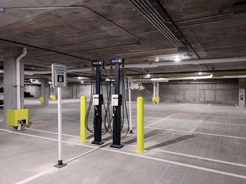 A parking garage with a sign that says "Electric Vehicle Charging Station".