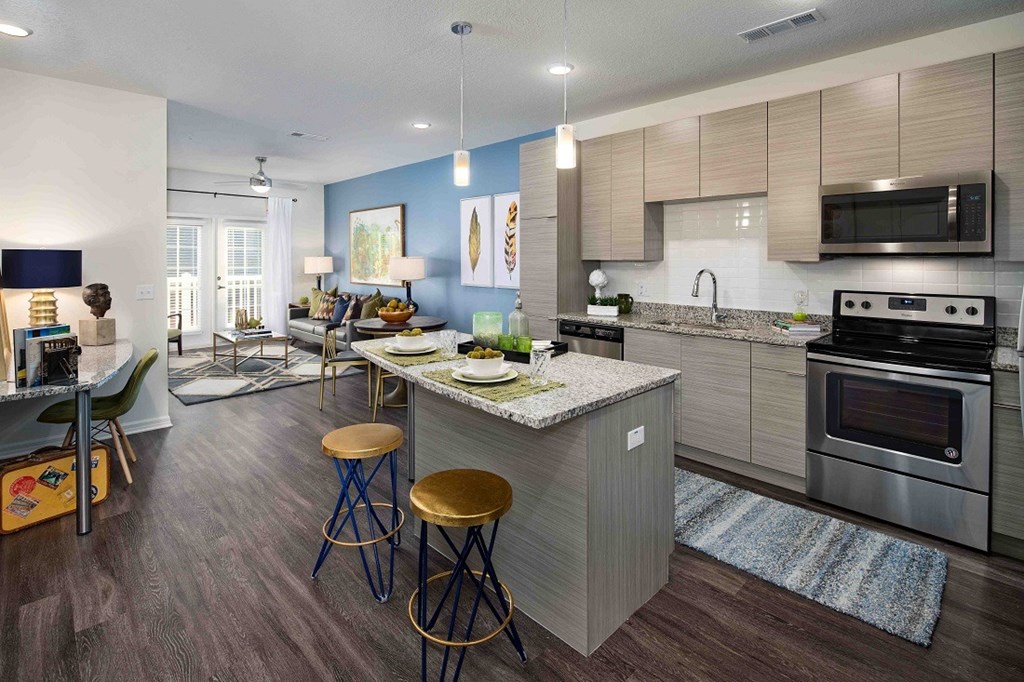 A modern kitchen with a bar stool and a countertop.