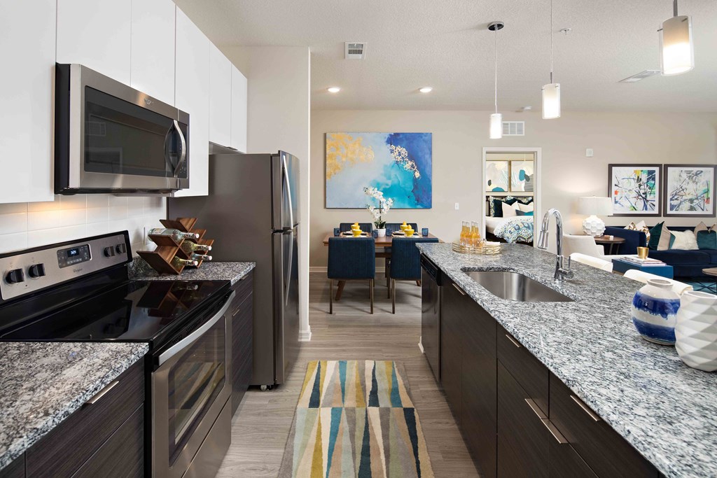 A kitchen with granite countertops and stainless steel appliances.