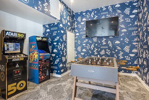 A room with Atari 50 arcade machines and a chess board.