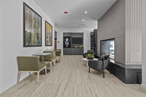 A modern living room with a long wooden floor and a grey sofa.