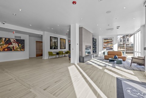 A spacious living room with a hardwood floor and a large rug.