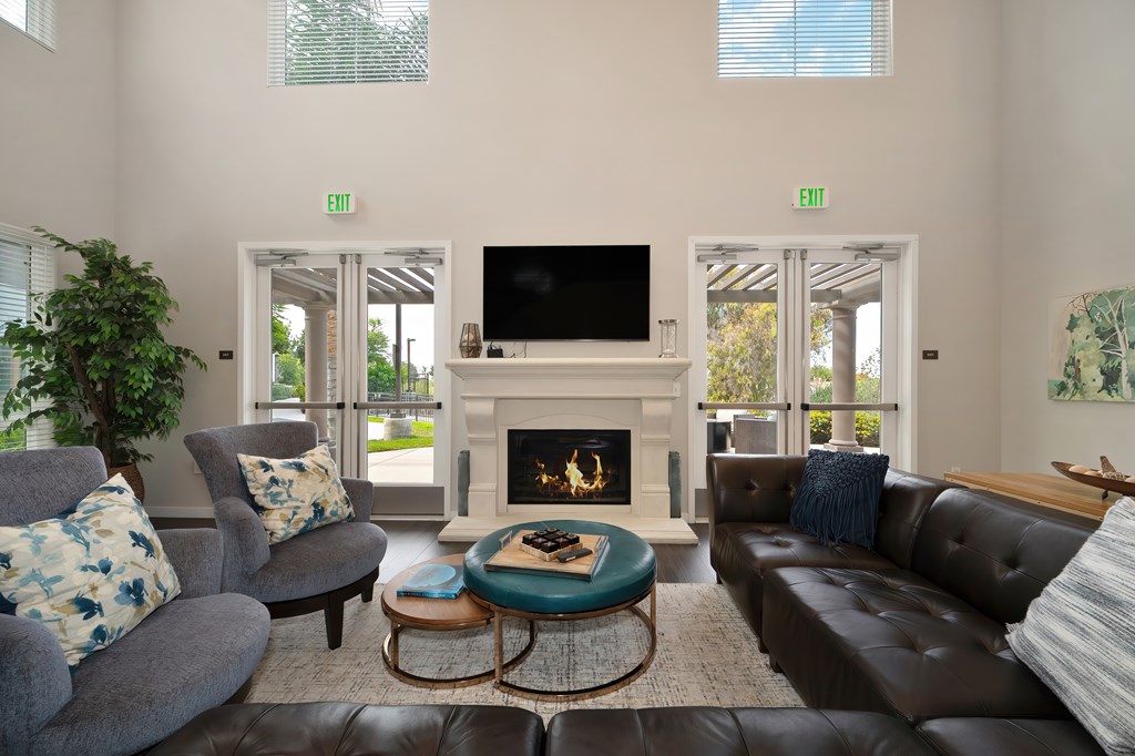 A living room with a fireplace and a flat screen TV.