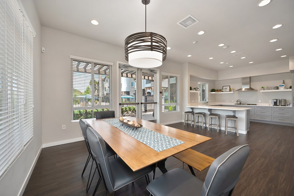 A modern dining room with a wooden table and chairs.