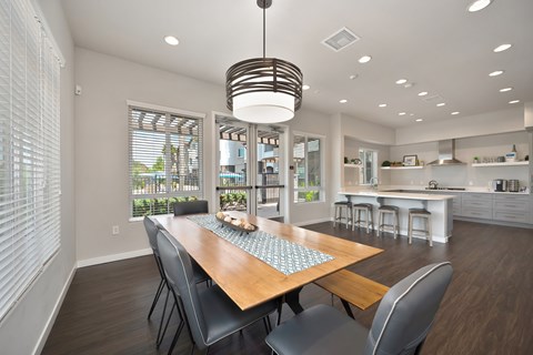 A modern dining room with a wooden table and chairs.
