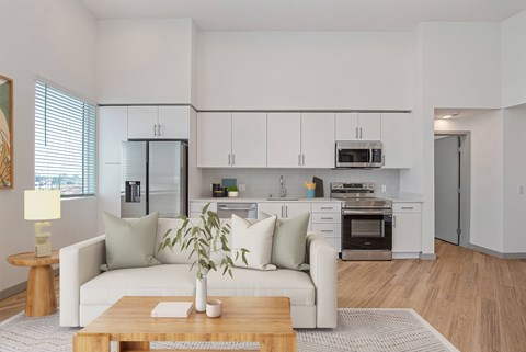 A modern living room with a white couch and a wooden coffee table.