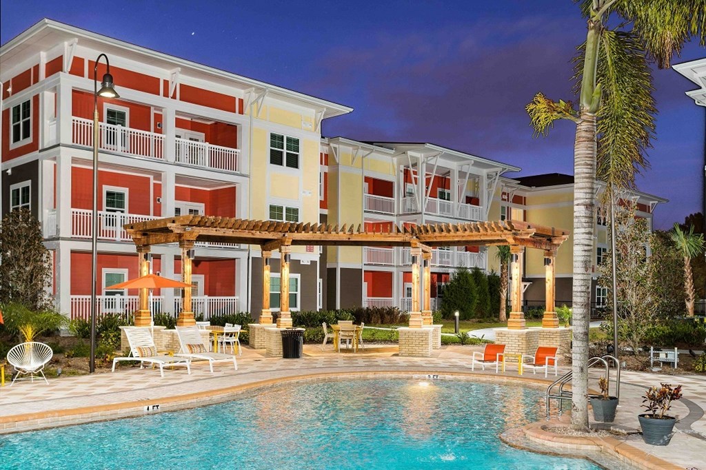 A pool area with a building in the background.