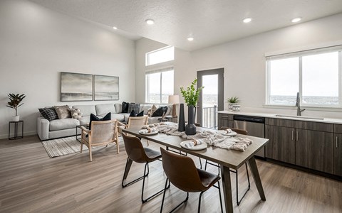 A modern dining room with a wooden table and chairs.