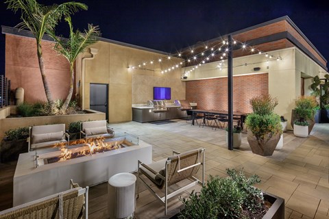 a patio with a fire pit and a bar