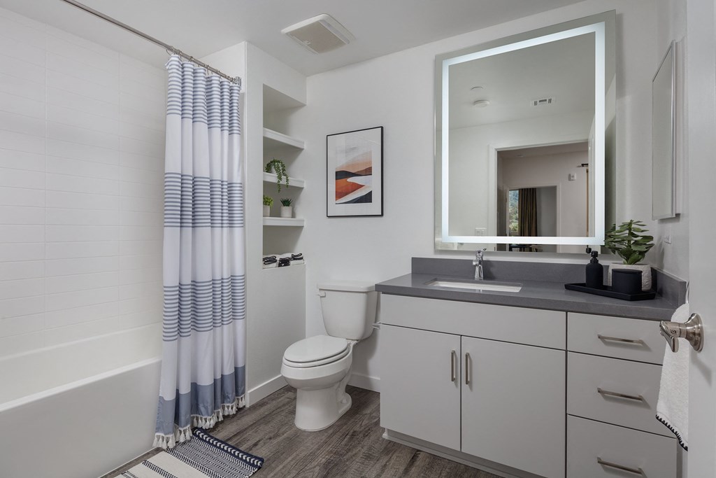 a bathroom with a toilet sink and bathtub in a 555 waverly unit
