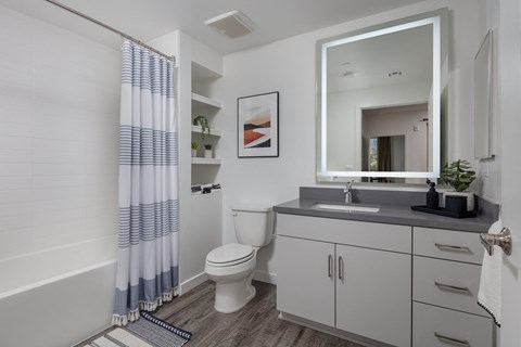 a bathroom with a toilet sink and bathtub in a 555 waverly unit