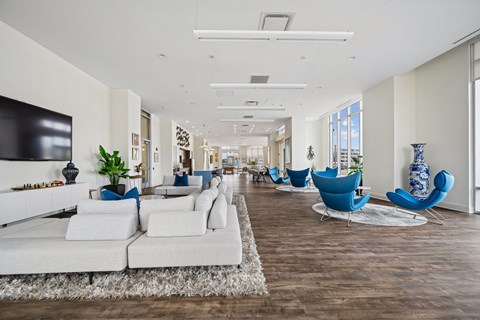A living room with white furniture and a wooden floor.