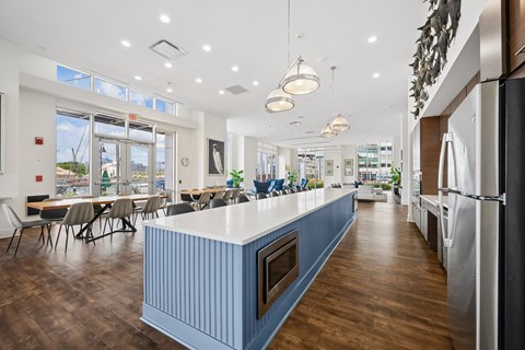 A modern kitchen with a long island and lots of counter space.