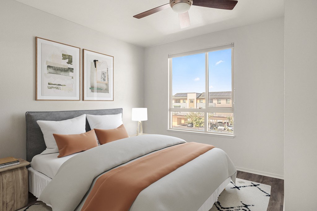 a bedroom with a large bed and a window