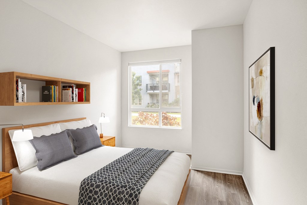 a bedroom with a large bed and a window