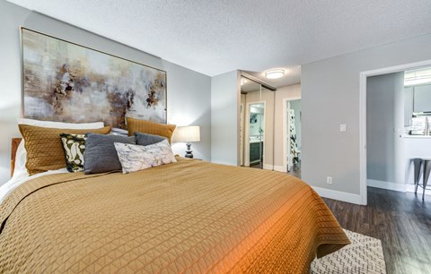 a bedroom with a large bed and a bathroom