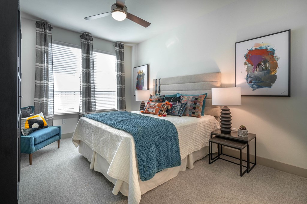 a bedroom with a bed and a ceiling fan