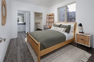 model bedroom with a bed and a large window model bedroom with a bed and a large window