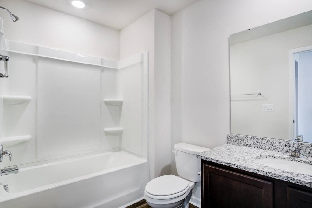 a bathroom with a toilet sink and bathtub at Berkeley Homes, Moncks Corner, SC 29461