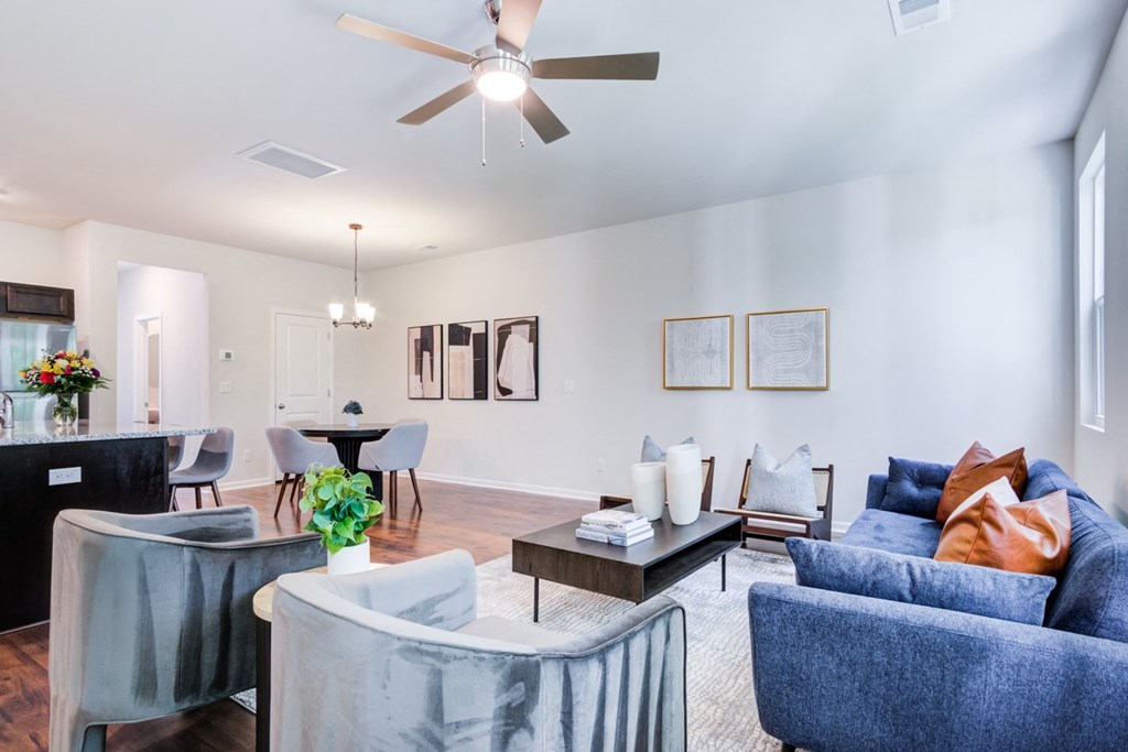 a living room with a ceiling fan and couches at Berkeley Homes, Moncks Corner, SC
