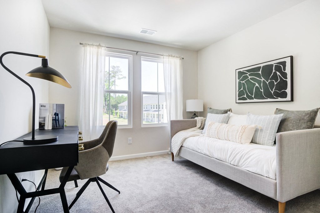 a bedroom with a bed and a desk with a chair at Berkeley Homes, South Carolina, 29461