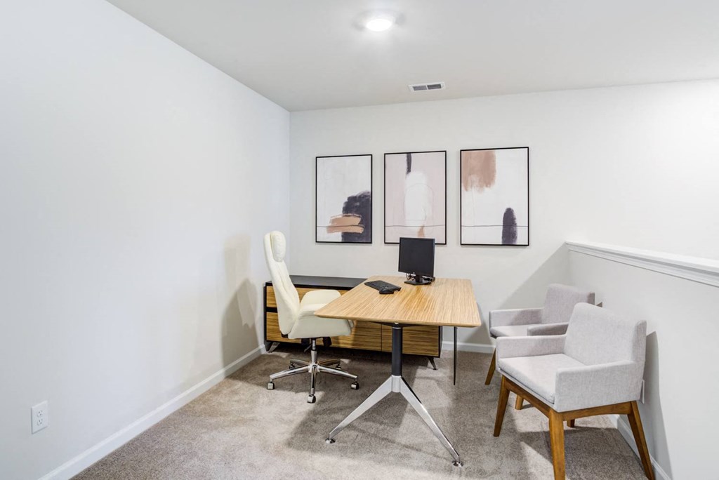 two chairs and a desk in an office with three paintings on the wall Office desk and chairs