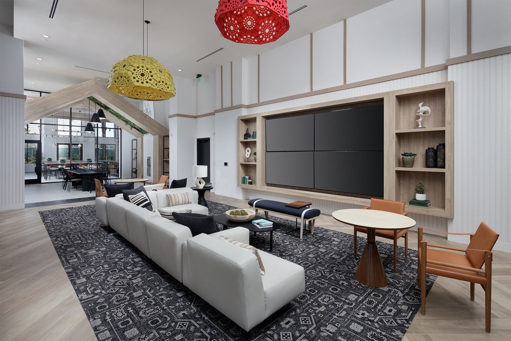 a rendering of a living room with white furniture and a large screen tv on the wall