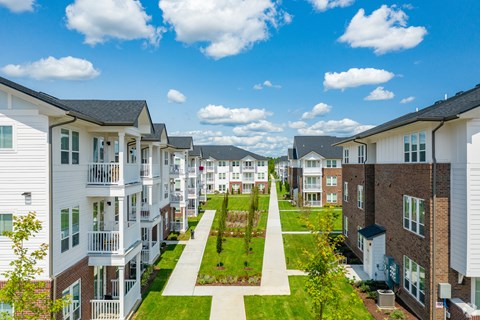 an aerial view of a row of town houses with lawns