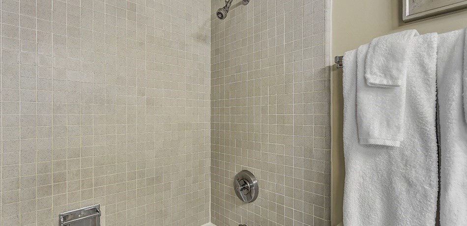 a bathroom with a shower and a towel rack