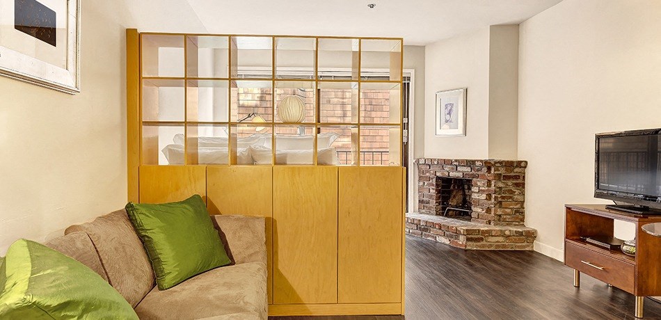 a living room with a couch and a fireplace