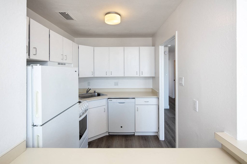 a kitchen with white cabinets and white appliances