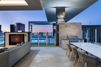 Two social courtyards with firepit, grilling and dining settings  at Stanza Little Italy, 92101