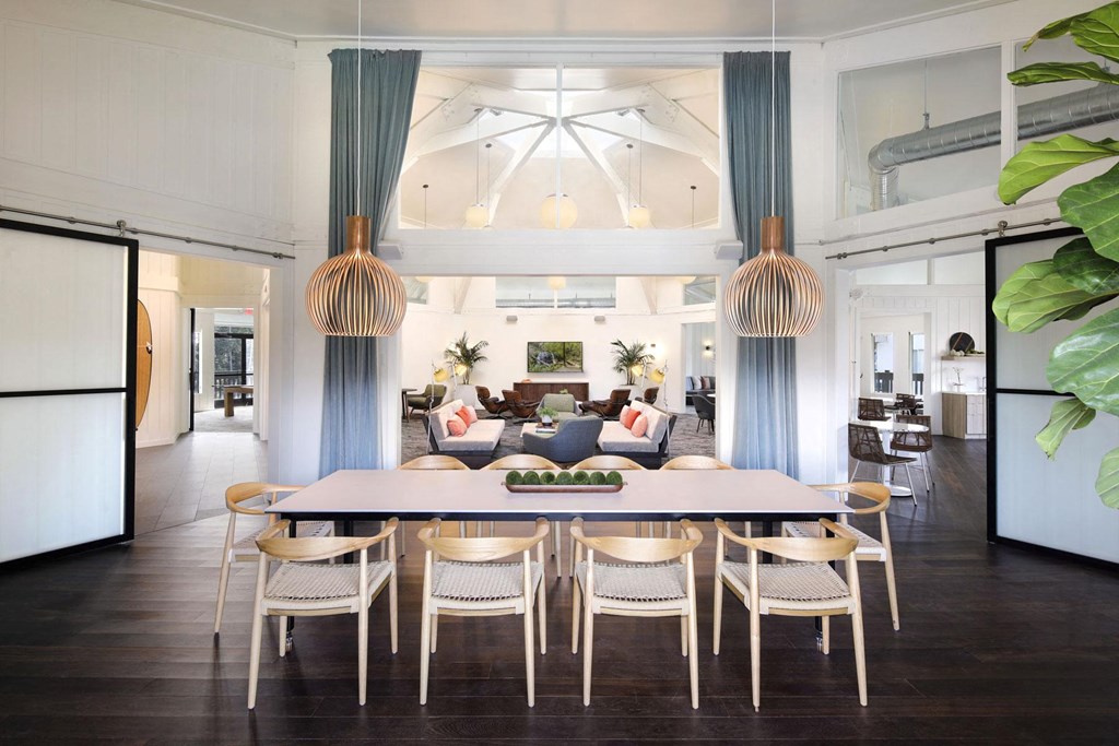 a dining room with a table and chairs and a living room