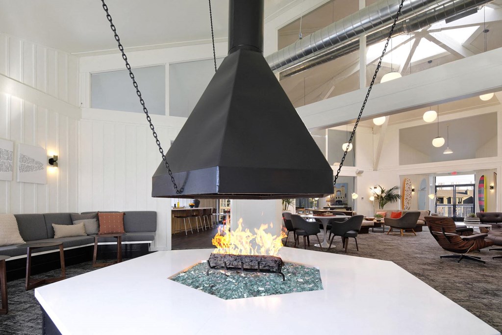 a large white table with a fireplace in a lobby