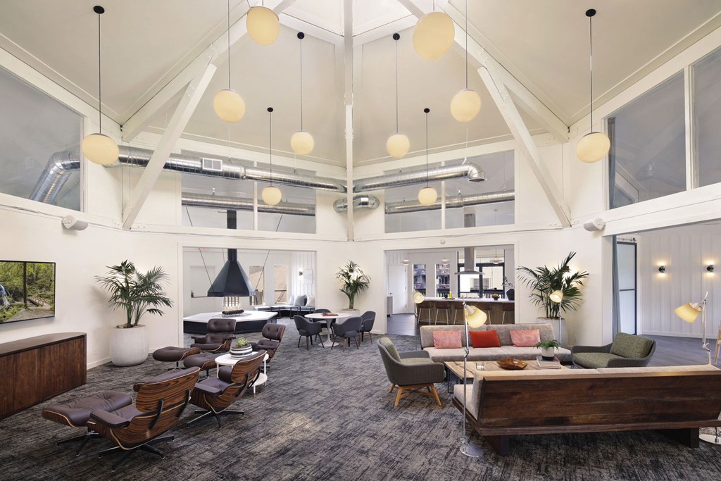 the lobby of a hotel with a large room with high ceilings