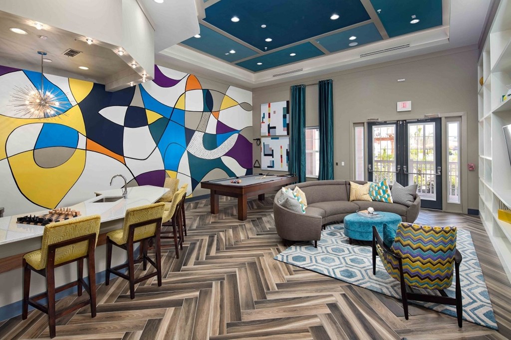 A modern dining room with a colorful mural on the wall.