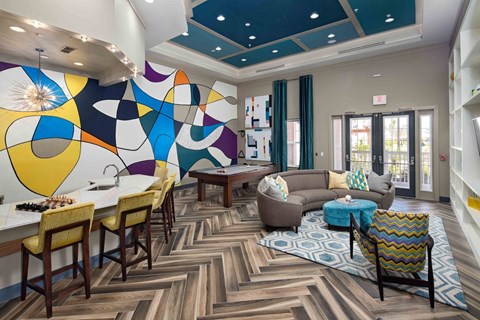 A modern dining room with a colorful mural on the wall.