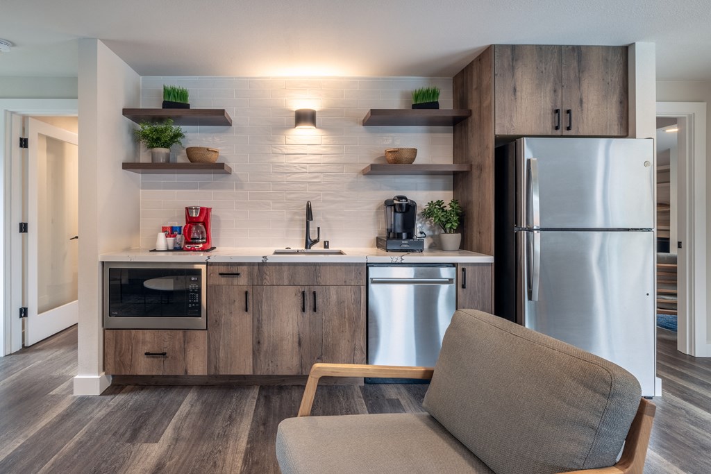 a kitchen with stainless steel appliances and a stainless steel refrigerator