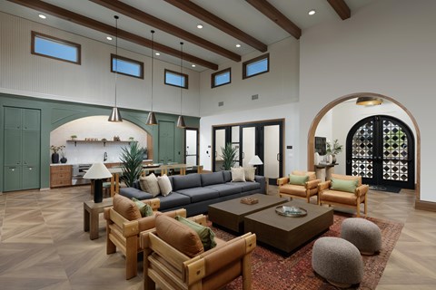 A living room with a dark sofa and wooden furniture.