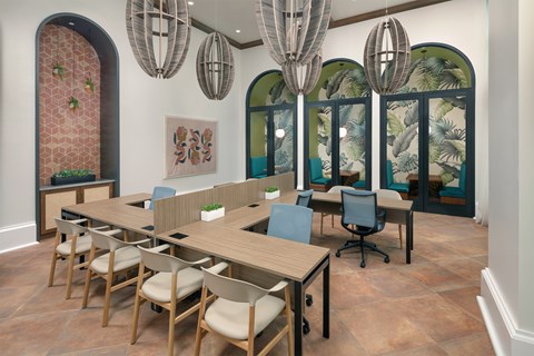 A conference room with a long table and chairs.