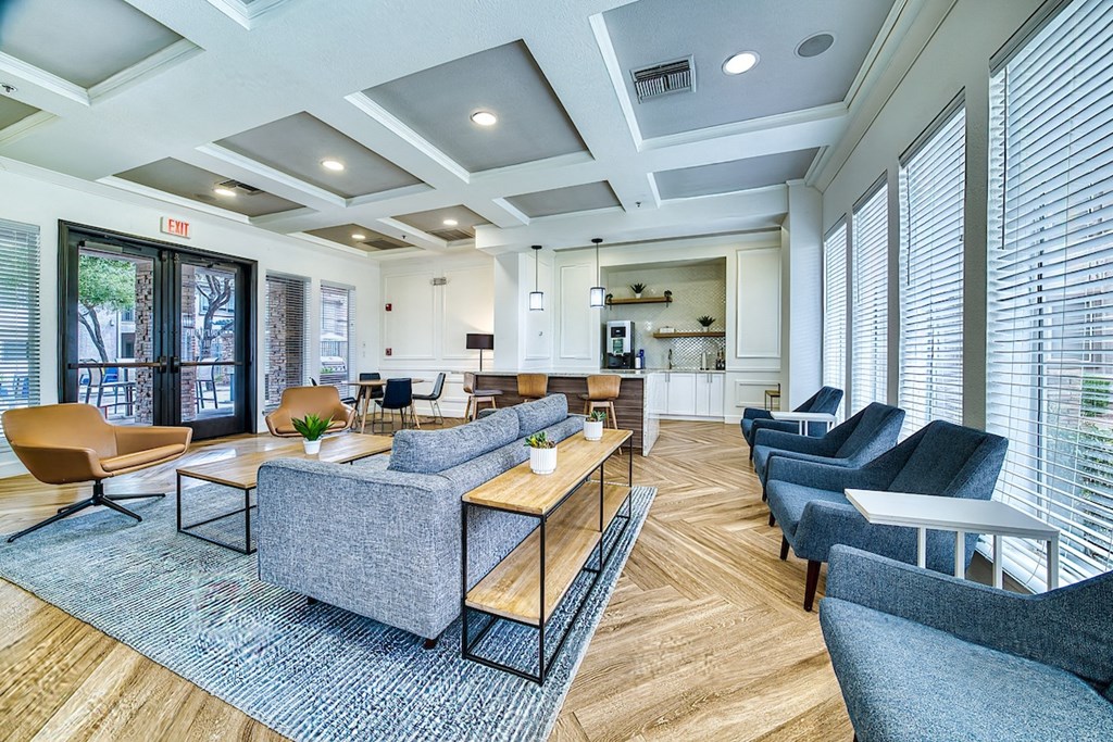 A spacious waiting room with a variety of seating options and a view of the street outside.