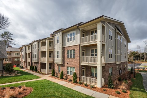 A large apartment building with multiple balconies and windows.